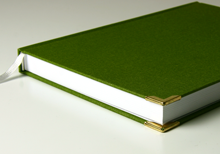 handmade book in green linen with book corners